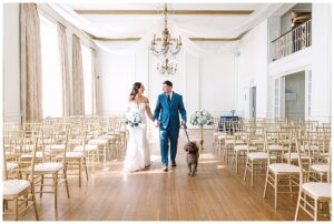 bride and groom pose for couples portraits with their dog at a historic venue in charlotte, NC