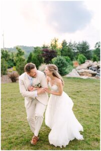 Bride and groom laughing and walking together outdoors.