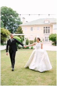 Bride and groom walking hand in hand at Separk Mansion.