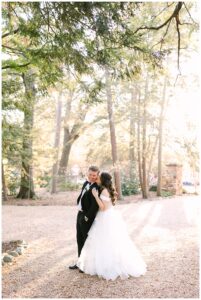 Bride and groom share a kiss surrounded by sunlight at Vanlandingham Estate, Charlotte, NC.