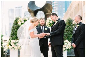 Bride and groom exchanging rings during the wedding ceremony.