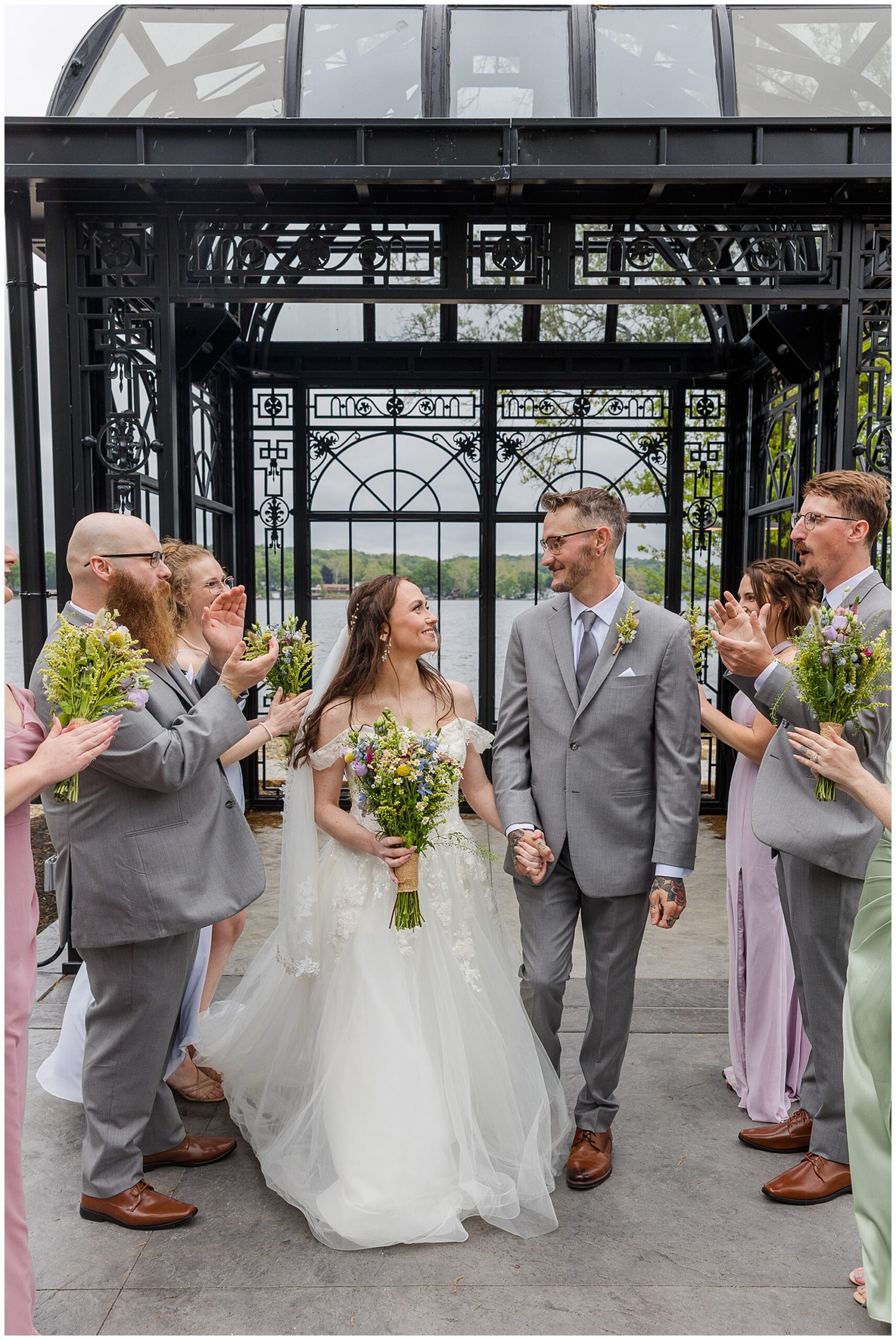 bride and groom walking through guest send off Tudor House Mason's Cove New Franklin Ohio
