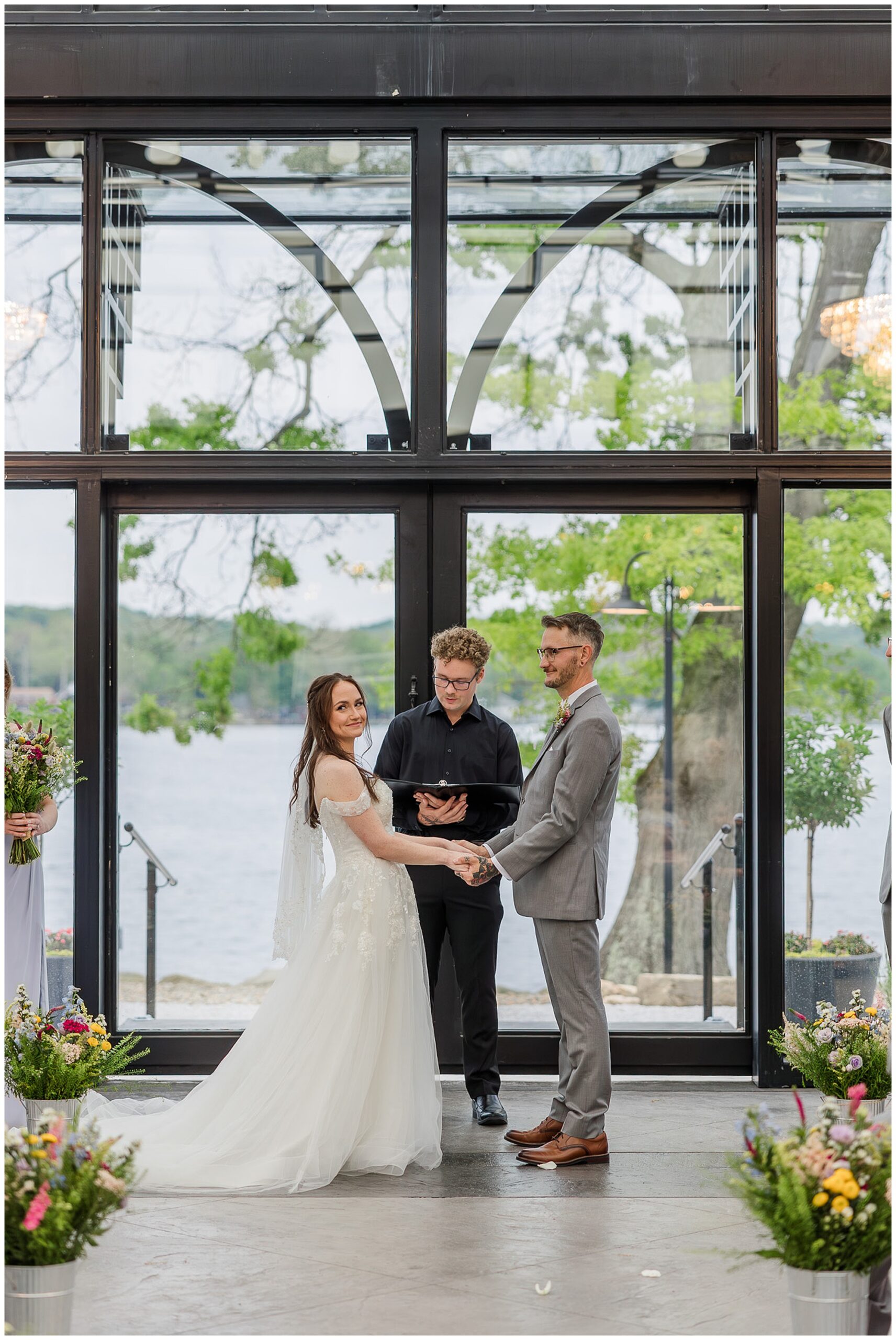 bride and groom holding hands during ceremony Tudor House Mason's Cove New Franklin Ohio