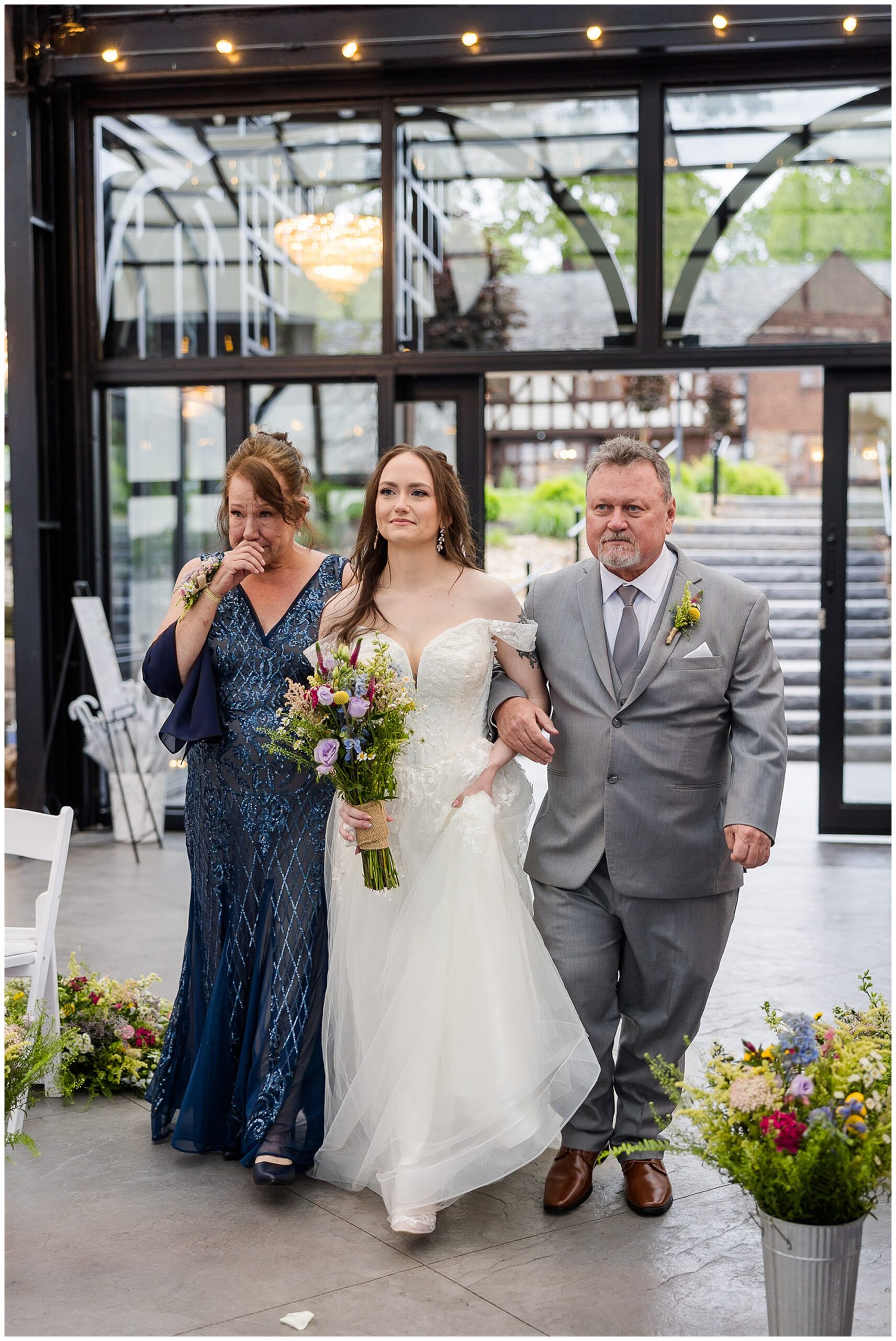 bride walking down aisle with mother and father Tudor House Mason's Cove Ohio wedding