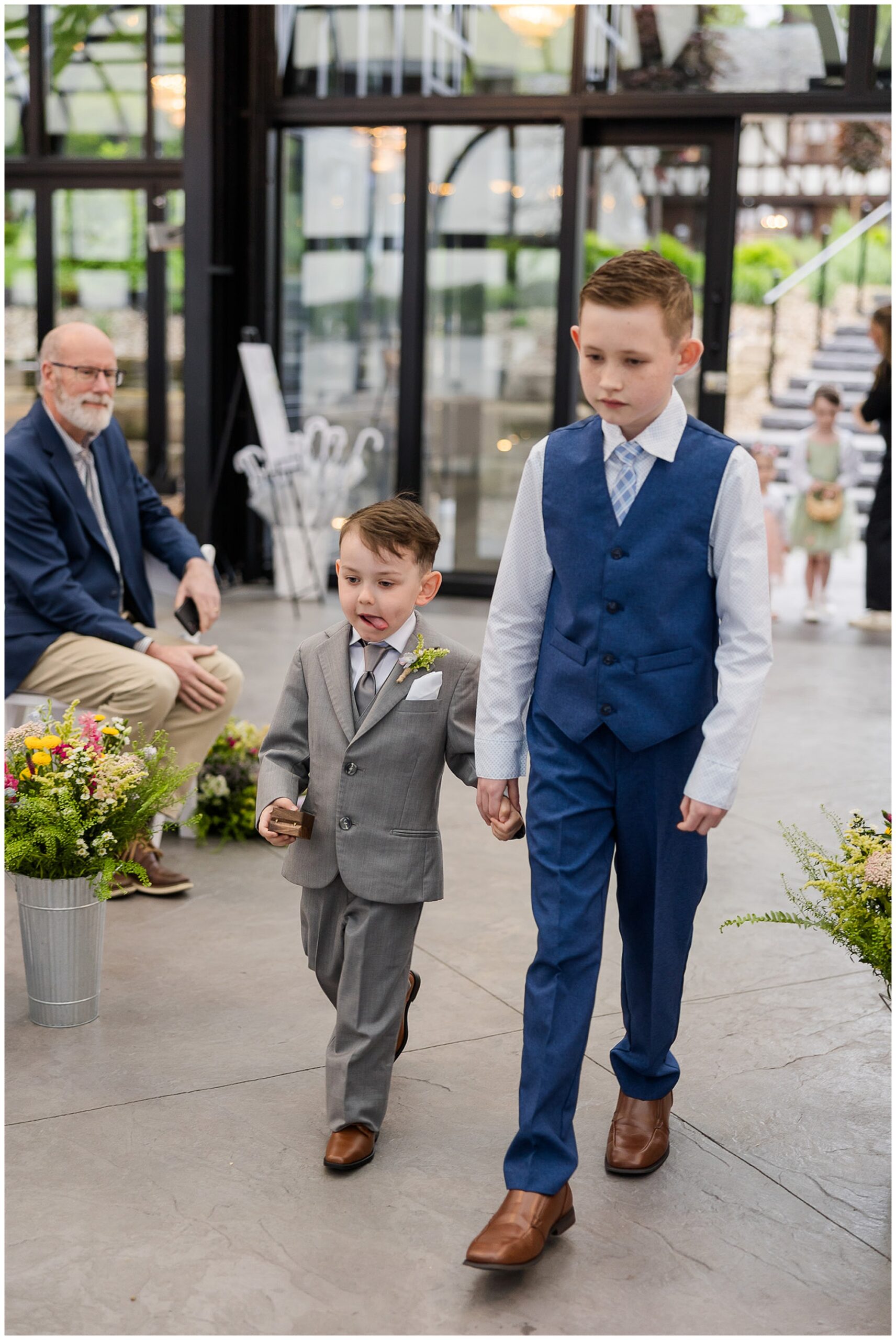 ring bearer walking down aisle Tudor House Mason's Cove Ohio wedding
