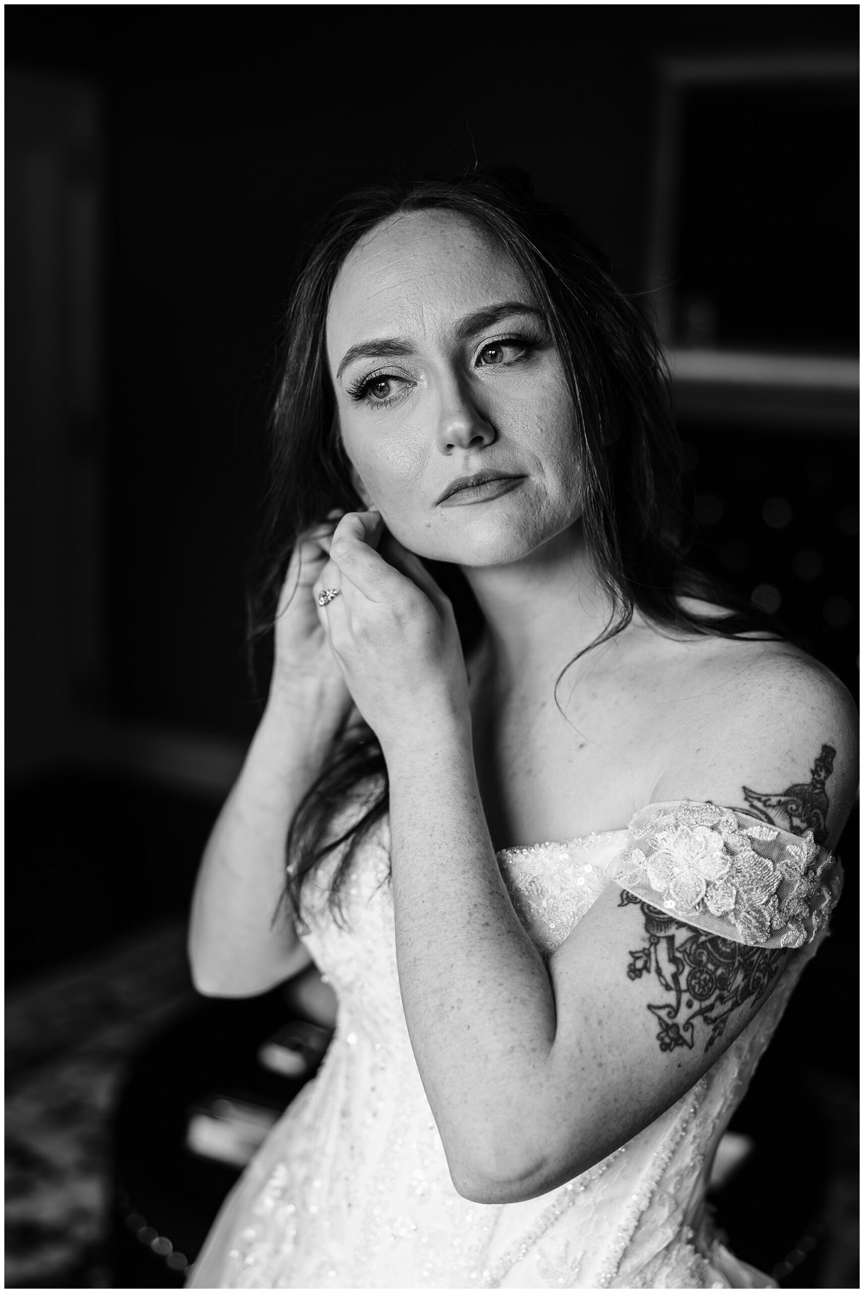 bride putting on earrings getting ready Tudor House Mason's Cove wedding photographer